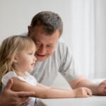 Bunic care își îmbrățișează nepoata, imagine ilustrativă pentru controversa din Irlanda privind consimțământul copiilor la îmbrățișări.